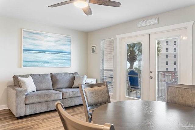 living room featuring french doors, ceiling fan, and light hardwood / wood-style flooring