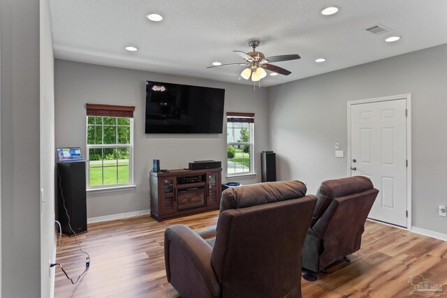 living room with plenty of natural light, ceiling fan, and hardwood / wood-style floors