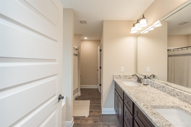 bathroom featuring wood-type flooring and vanity