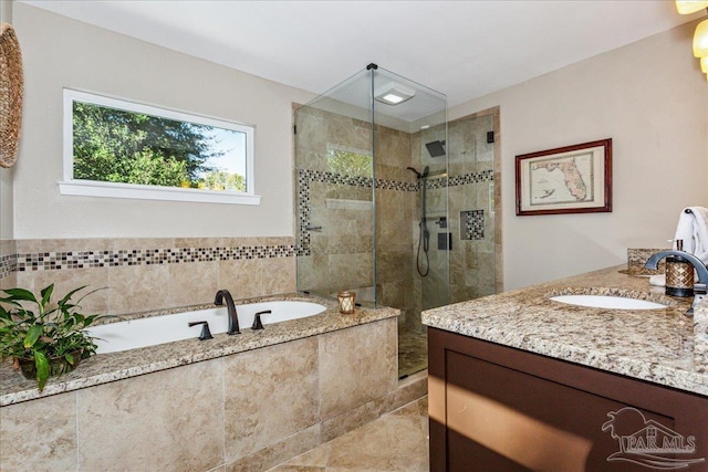 bathroom with plus walk in shower, tile patterned floors, and vanity