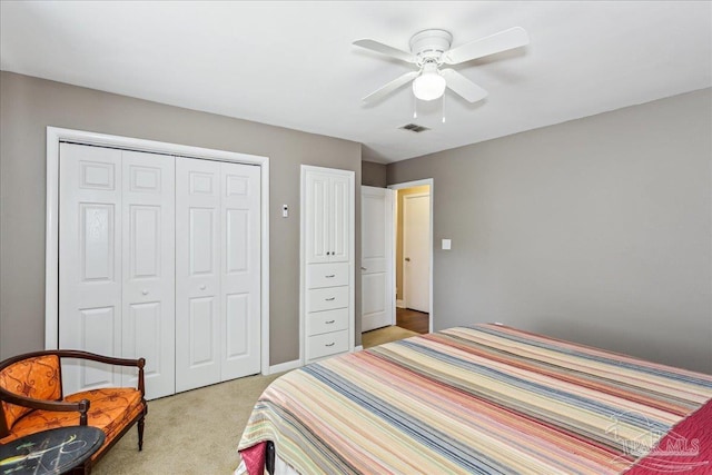 carpeted bedroom featuring a closet and ceiling fan