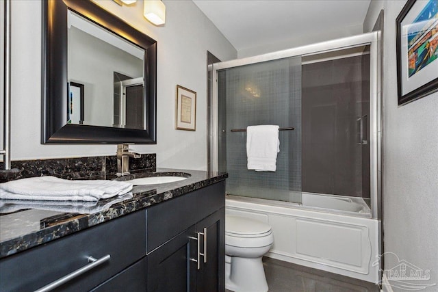 full bathroom with shower / bath combination with glass door, vanity, and toilet