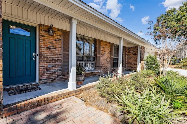 view of exterior entry with a porch