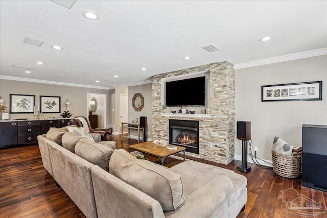 living room with a stone fireplace, crown molding, and dark hardwood / wood-style flooring