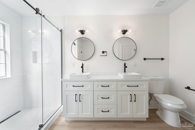 full bathroom with a stall shower, visible vents, and a sink