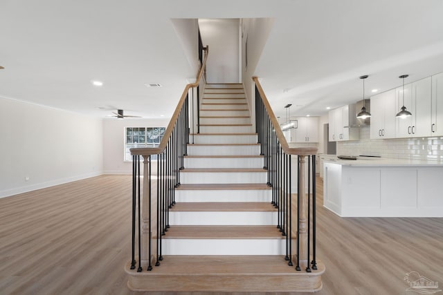 stairs featuring recessed lighting, baseboards, a ceiling fan, and wood finished floors