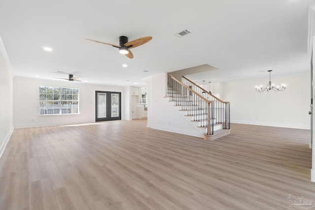 unfurnished living room with stairway, baseboards, recessed lighting, ceiling fan with notable chandelier, and light wood-type flooring