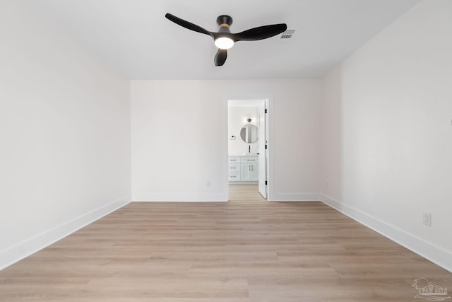 unfurnished room with ceiling fan, visible vents, baseboards, and light wood-style flooring