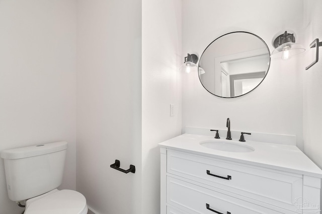 half bathroom featuring toilet and vanity