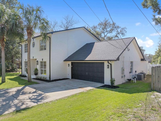 view of front of house with brick siding, a front lawn, fence, concrete driveway, and a garage