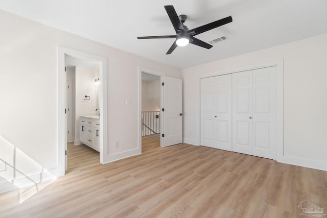 unfurnished bedroom featuring visible vents, baseboards, ceiling fan, light wood-style floors, and a closet