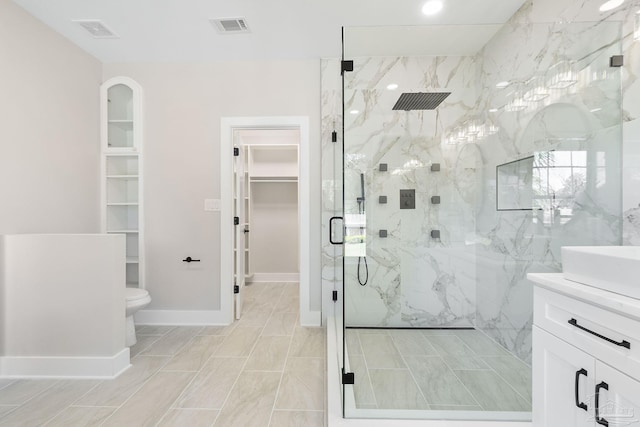 full bath with a marble finish shower, visible vents, a spacious closet, and toilet