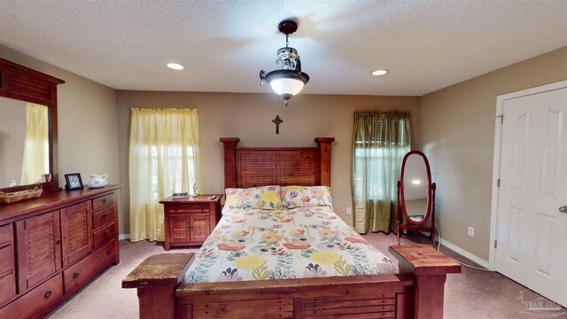 bedroom featuring a textured ceiling, ceiling fan, and light carpet