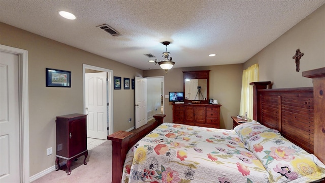 carpeted bedroom featuring baseboards, visible vents, a textured ceiling, and recessed lighting