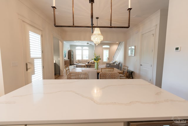 800 N Baylen St, Pensacola, FL 32501 - kitchen featuring open floor plan, ornamental molding, light stone counters, a center island, and a chandelier