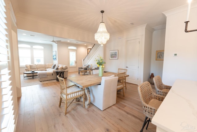 800 N Baylen St, Pensacola, FL 32501 - dining area featuring light wood finished floors, stairway, a chandelier, crown molding, and ceiling fan