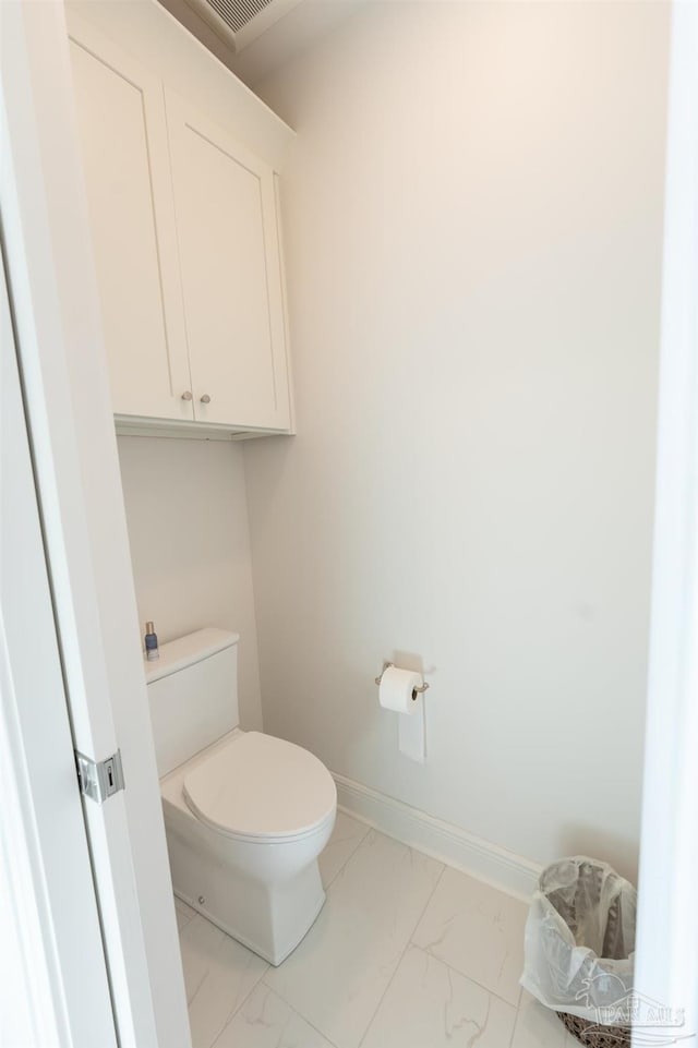 800 N Baylen St, Pensacola, FL 32501 - bathroom with marble look tiles, toilet, and baseboards