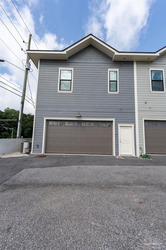 800 N Baylen St, Pensacola, FL 32501 - view of side of property featuring an attached garage and asphalt driveway
