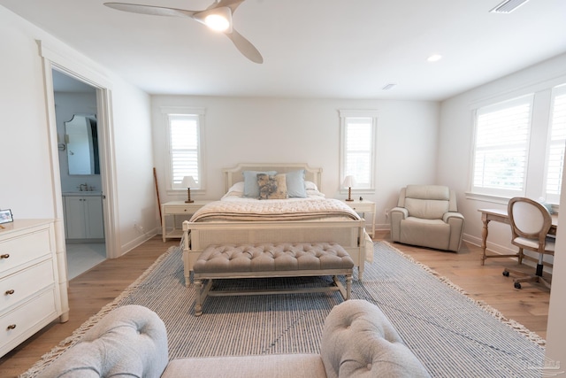 800 N Baylen St, Pensacola, FL 32501 - bedroom featuring light wood-style flooring, baseboards, a ceiling fan, ensuite bathroom, and a sink