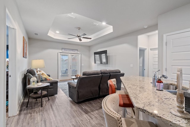 5323 Red Shoulder Rd, Pace, FL 32571 - living area featuring wood finished floors, ceiling fan, recessed lighting, baseboards, and a raised ceiling