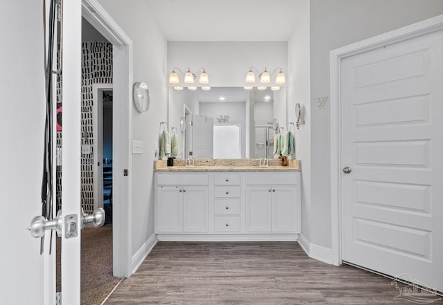 5323 Red Shoulder Rd, Pace, FL 32571 - full bath featuring double vanity, wood finished floors, and baseboards