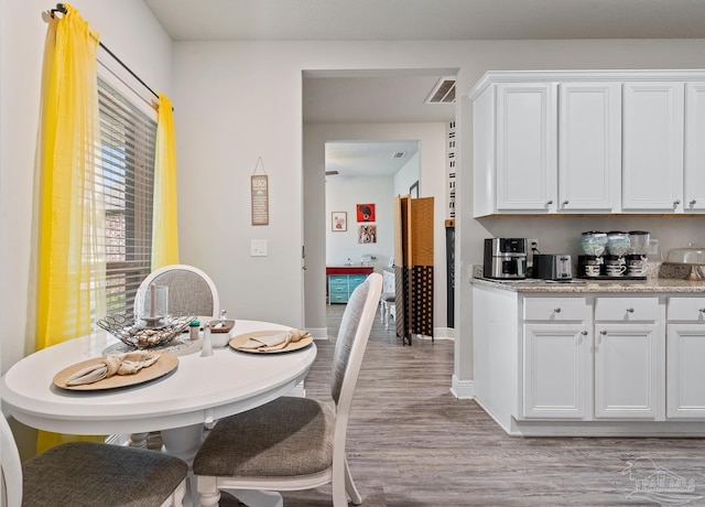 5323 Red Shoulder Rd, Pace, FL 32571 - dining room with light wood-style flooring and baseboards