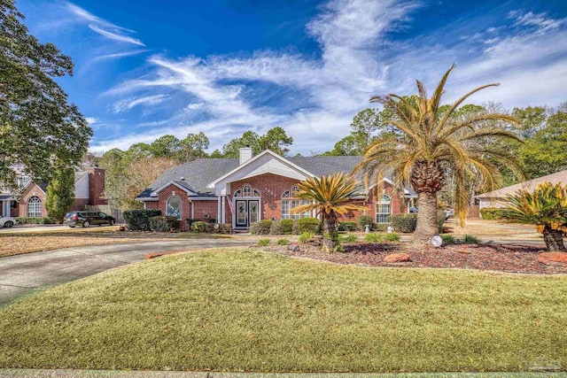 ranch-style house featuring a front lawn