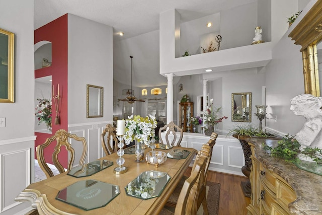 dining room with ceiling fan, dark hardwood / wood-style floors, and ornate columns