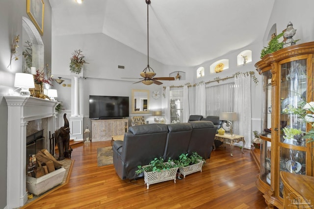 living room with ceiling fan, wood-type flooring, and high vaulted ceiling