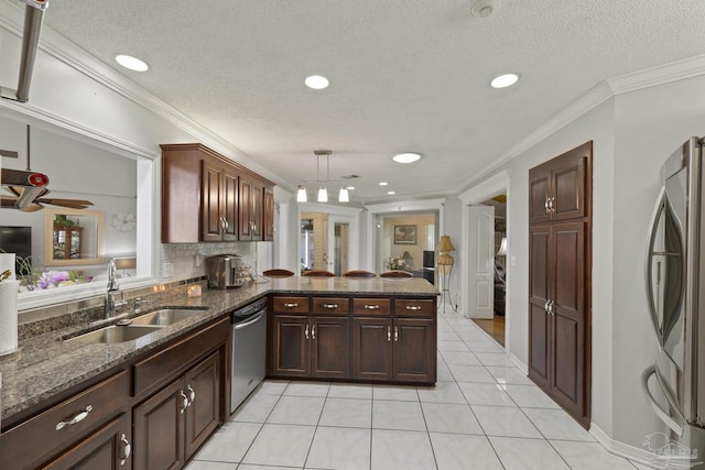 kitchen featuring appliances with stainless steel finishes, sink, hanging light fixtures, ornamental molding, and kitchen peninsula