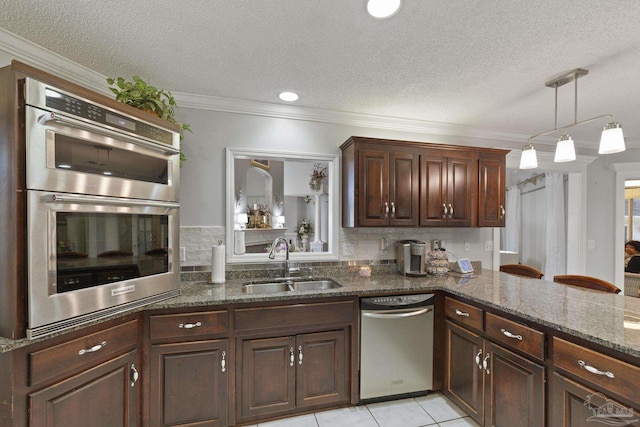 kitchen with stainless steel appliances, sink, decorative backsplash, and dark stone countertops