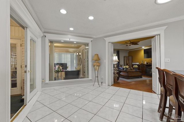 interior space featuring ornamental molding and ceiling fan