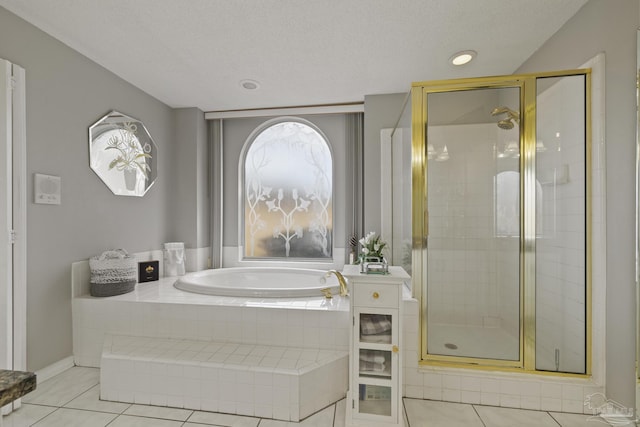 bathroom with tile patterned floors, shower with separate bathtub, and a textured ceiling