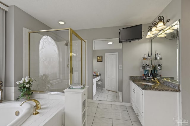 bathroom with tile patterned flooring, vanity, and separate shower and tub