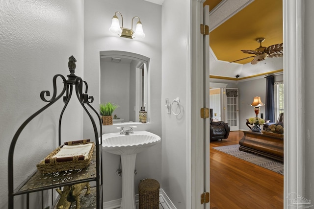 bathroom with hardwood / wood-style flooring and ceiling fan