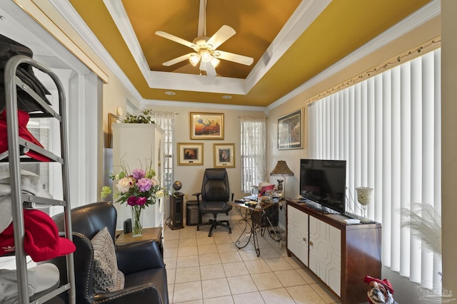 interior space featuring crown molding, ceiling fan, a tray ceiling, and light tile patterned floors