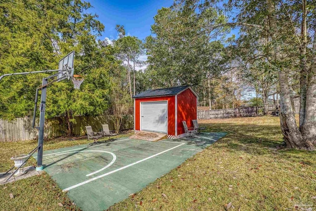 view of sport court with a lawn