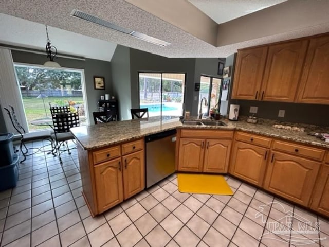 kitchen with light tile patterned flooring, dishwashing machine, sink, and kitchen peninsula