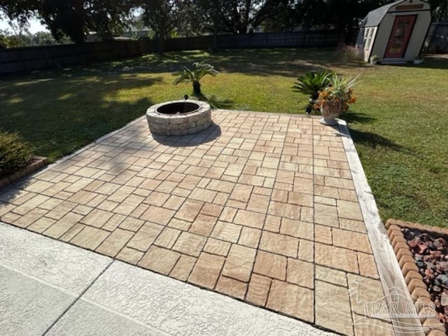 view of patio / terrace featuring a storage unit and an outdoor fire pit