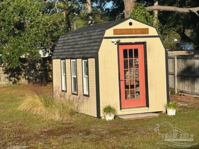 view of outdoor structure featuring a lawn