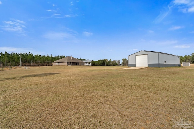 view of yard featuring an outbuilding and a garage