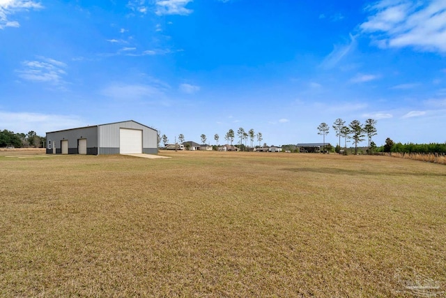 view of yard featuring a garage and an outdoor structure