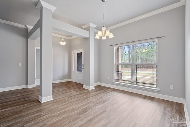 unfurnished dining area featuring a notable chandelier, wood-type flooring, and ornamental molding