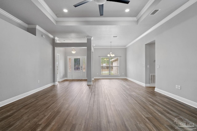 unfurnished living room with dark hardwood / wood-style flooring, a tray ceiling, and ornamental molding