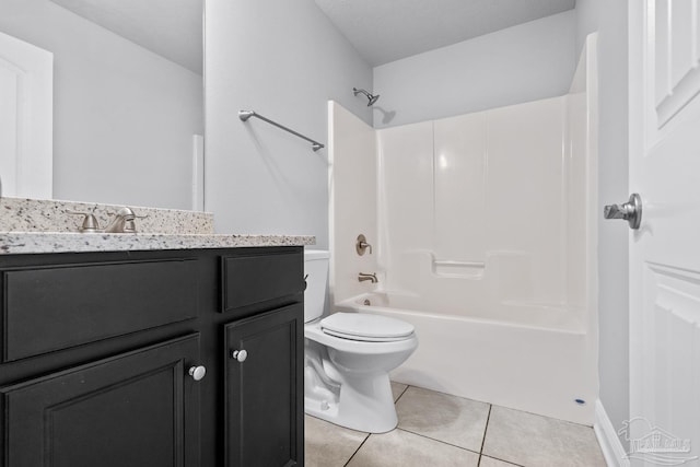 full bathroom with washtub / shower combination, tile patterned floors, toilet, and vanity