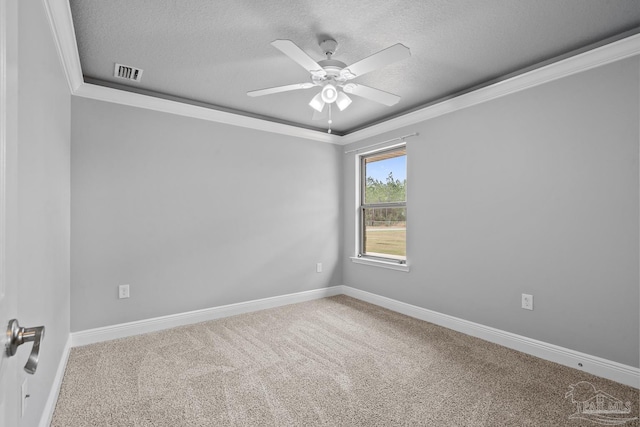 carpeted empty room featuring ceiling fan, ornamental molding, and a textured ceiling