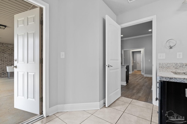 bathroom featuring vanity, crown molding, and tile patterned floors