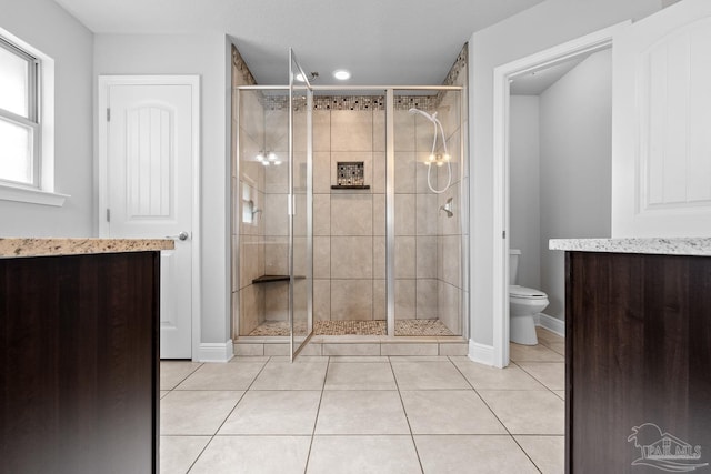 bathroom featuring an enclosed shower, tile patterned floors, and toilet