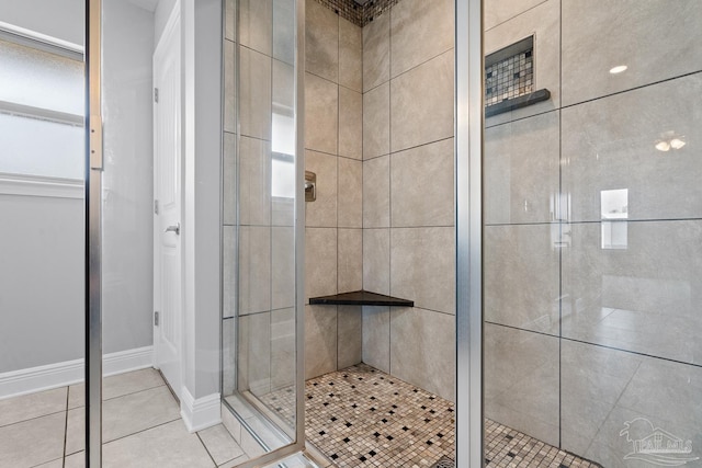 bathroom with tile patterned floors and a shower with shower door