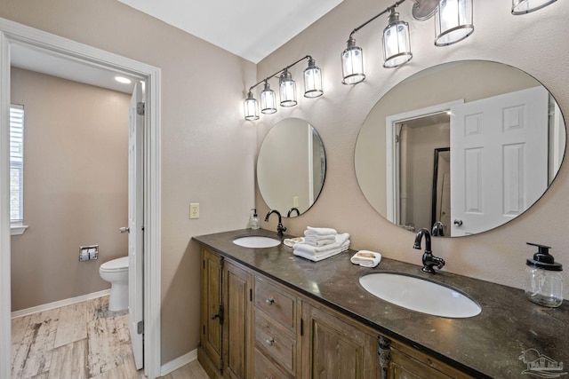 35868 Boykin Blvd, Lillian, AL 36549 - bathroom featuring double vanity, a sink, toilet, and baseboards